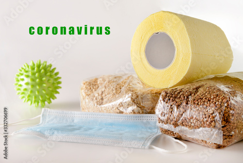 cereals, toilet paper, buckwheat, oat flakes, medical mask on a white , coronavirus, covit 19 photo