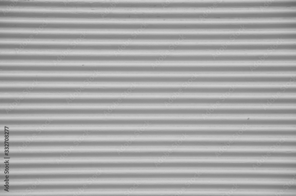 Old gray external metal shutter at store closeup Old gray external metal shutter at store closeup