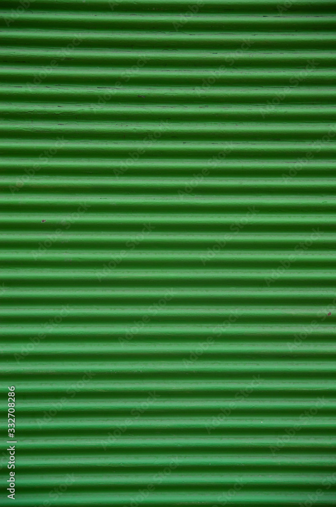 Old green external metal shutter at store closeup Old green external metal shutter at store closeup