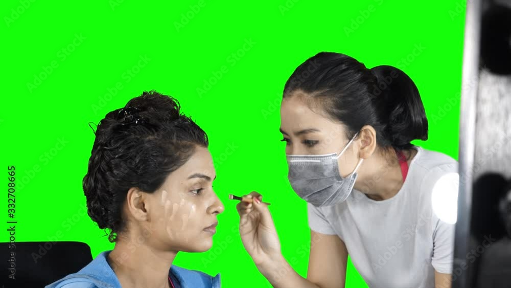 Makeup artist doing makeup with beauty blender Makeup artist doing makeup with beauty blender