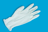 Light medical hygiene glove on a blue background