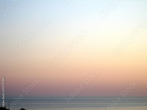 A flat horizon between the sky and the sea at sunset on a clear day.