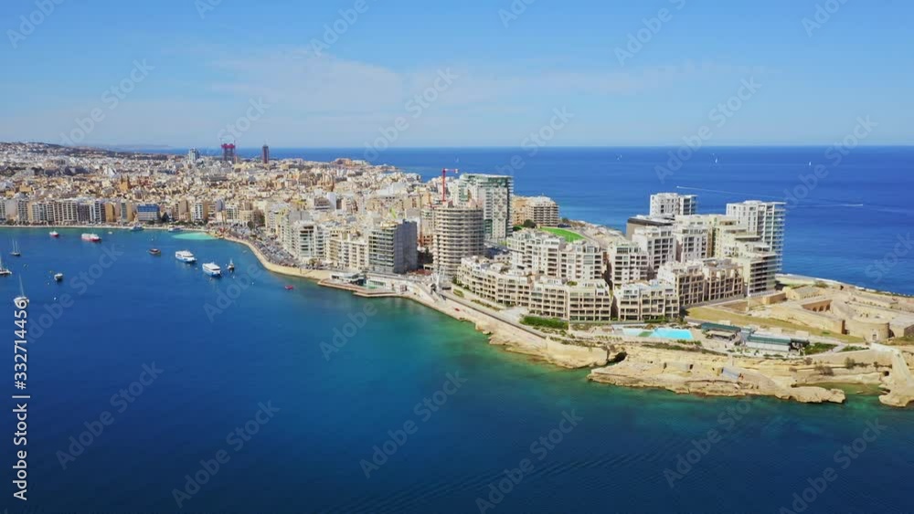 Aerial view of Sliema city. Buildings, apartments, boats, road, blue sky, Mediterranean sea. Malta country Aerial view of Sliema city. Buildings, apartments, boats, road, blue sky, Mediterranean sea. Malta country