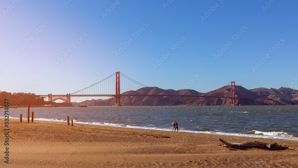Beautiful view from Crissy Field beach of famous Golden Gate Bridge In the light of the setting sun.