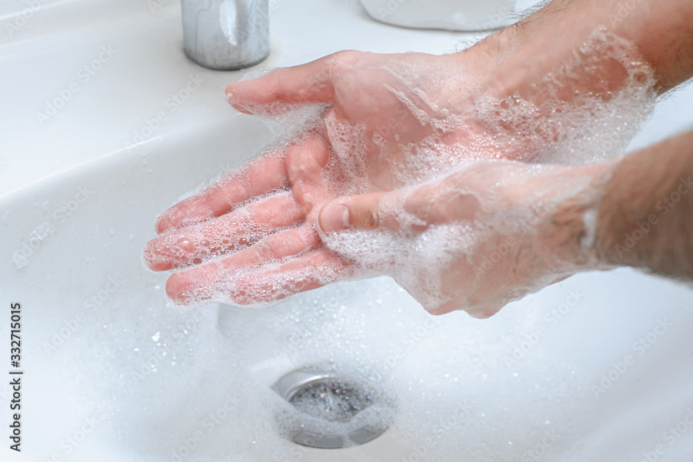 Soapy hands in the foam. Hand washing with soap to prevent coronavirus, hygiene to stop the spread of coronavirus. Protection against a pandemic of the crown virus by frequent hand washing. Soapy hands in the foam. Hand washing with soap to prevent coronavirus, hygiene to stop the spread of coronavirus. Protection against a pandemic of the crown virus by frequent hand washing.