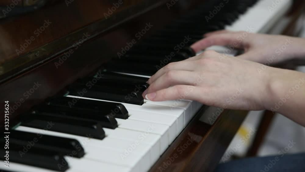 Woman is playing piano. Hands on the keyboard. Beautiful music. Creative girl at the musical instrument. Classical art. Woman is playing piano. Hands on the keyboard. Beautiful music. Creative girl at the musical instrument. Classical art.