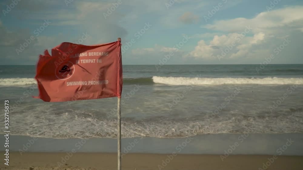 flag on the beach with the words swimming prohibited flag on the beach with the words swimming prohibited
