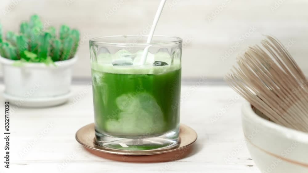 Matcha Latte Tea, Barista crafts a colorful matcha latte in coffee shop. Matcha Latte Tea, Barista crafts a colorful matcha latte in coffee shop.