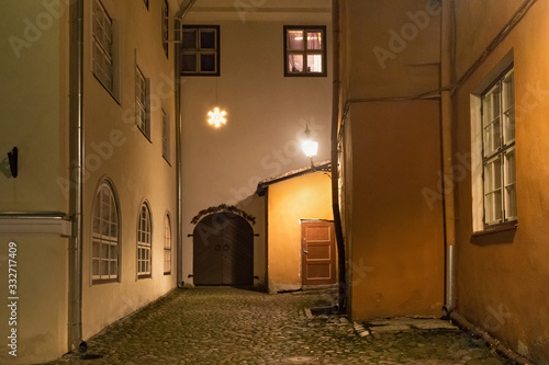 Night view of the old courtyard in the historical part of Tallinn. The city is the capital and the most populous city of Estonia. © Renar