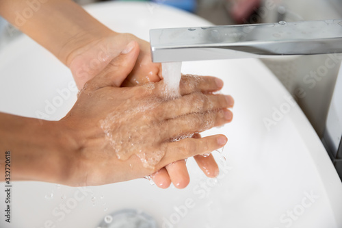Close up of caucasian woman cleans hands under running water. Concept of personal hygiene and morning routine, water crisis problem, stop corona virus or 2019-ncov worldwide epidemic outbreak disaster