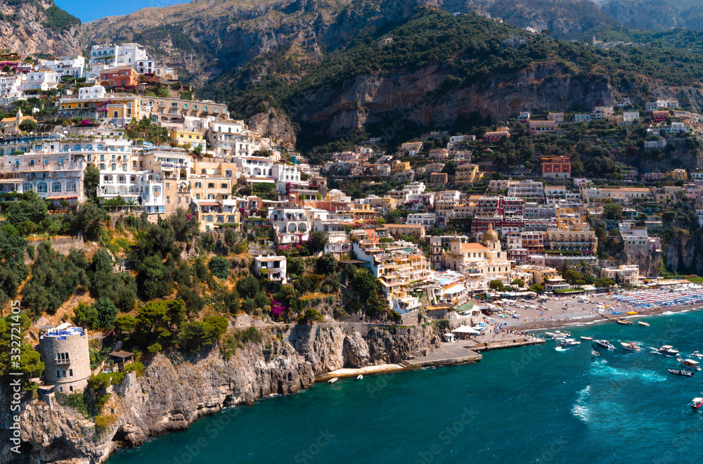 Beautiful aerial panorama view of Positano bay. Rocky shores and incredible beaches, Luxury yachts, boats and hotels, apartments overlooking Tyrrhenian Sea. Bright sunny day. Positano, Italy