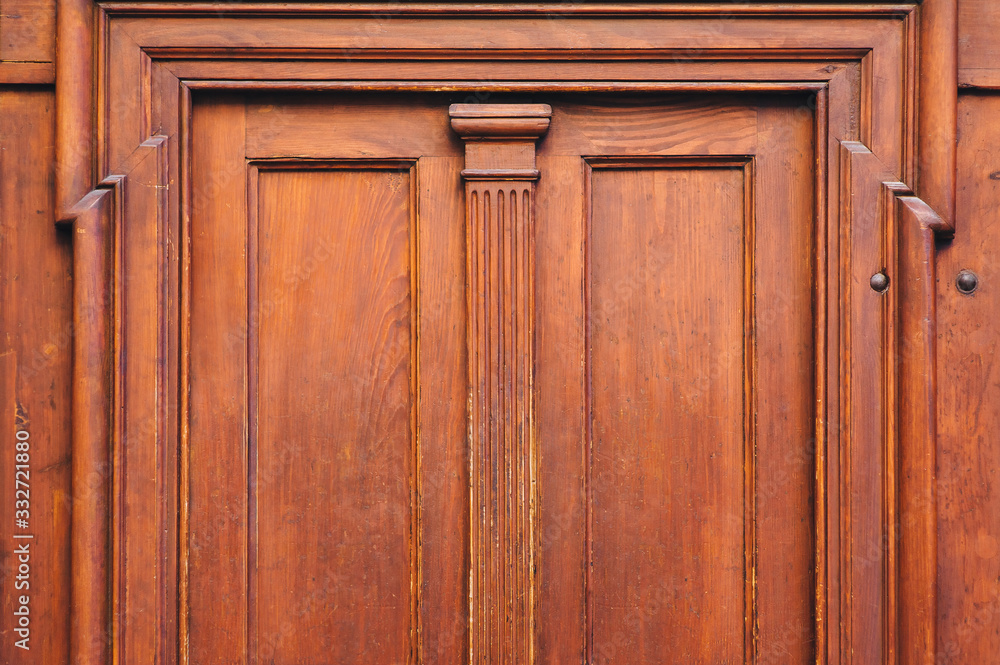 Antique luxury wooden door surrounded by handmade decor and carvings. Mahogany, portal to an ancient building. Antique luxury wooden door surrounded by handmade decor and carvings. Mahogany, portal to an ancient building.