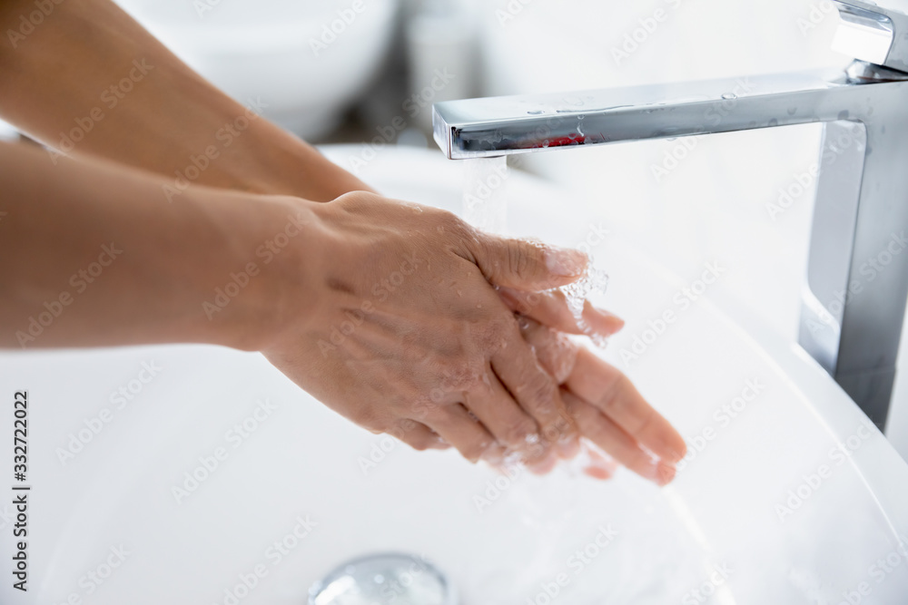 Close up woman cleans hands wash away dirt under running water from tap. Due to 2019-ncov corona virus outbreak, handwashing important part of personal hygiene, Stop ncov, keep your arms clean concept Close up woman cleans hands wash away dirt under running water from tap. Due to 2019-ncov corona virus outbreak, handwashing important part of personal hygiene, Stop ncov, keep your arms clean concept