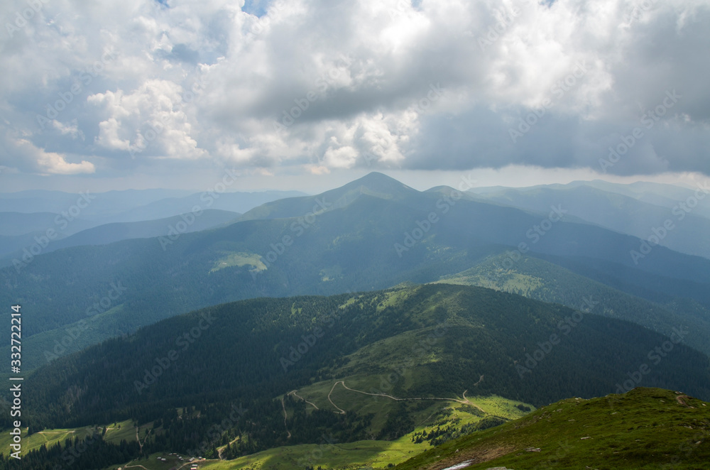 View from Mount Petros in the Carpathian Mountains in the background of the sky with clouds. This is the highest point of the Ukrainian Carpathians - Goverla (Hoverla) Mountain.