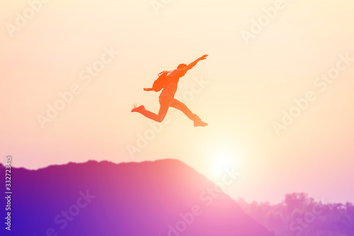 Happy man jumping against beautiful sunset. Freedom, enjoyment concept.