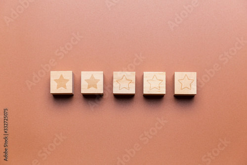 Wooden cubes with 2 stars out of 5, concept of rating and evaluation