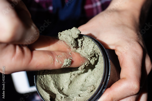 Woman using organic cosmetic mask (scrub) with natural extracts