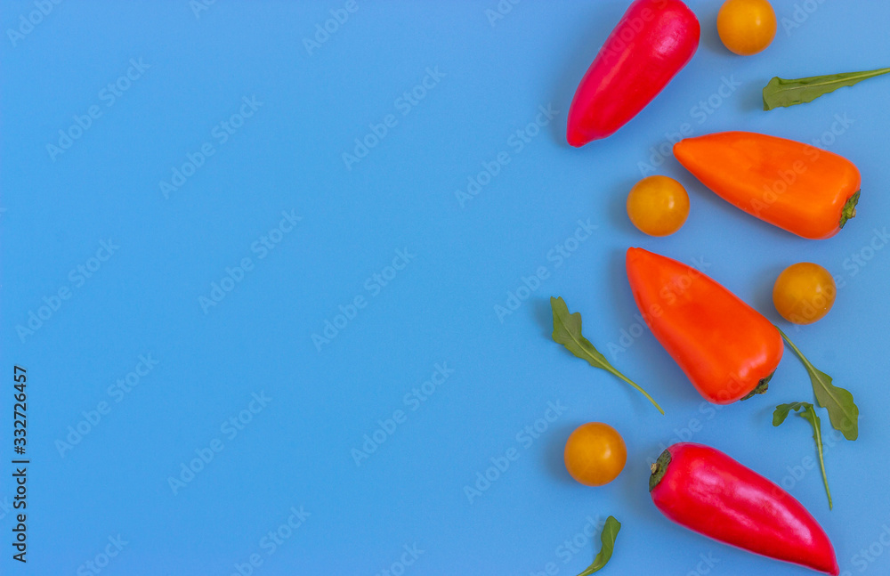 Set fresh vegetables, tomatoes, peppers on a blue background. Healthy food concept. Flat lay, top view. Copy space Set fresh vegetables, tomatoes, peppers on a blue background. Healthy food concept. Flat lay, top view. Copy space