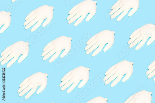 Concept of prevention from coronavirus with rubber latex gloves on blue background. © IrynaV