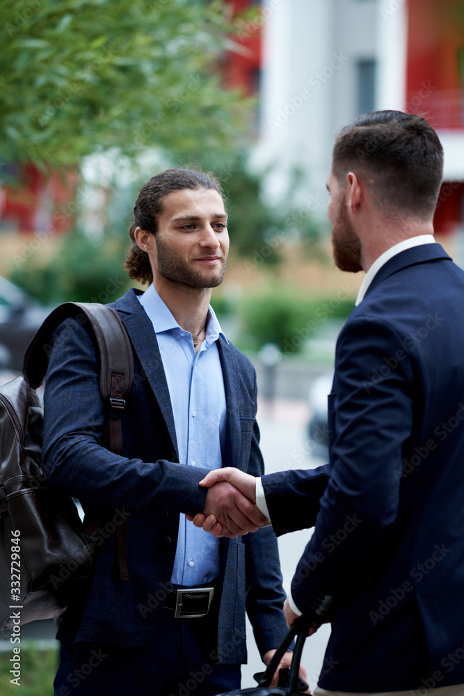Business men shaking hands, starting up a meeting. Elegancy and male style Business men shaking hands, starting up a meeting. Elegancy and male style