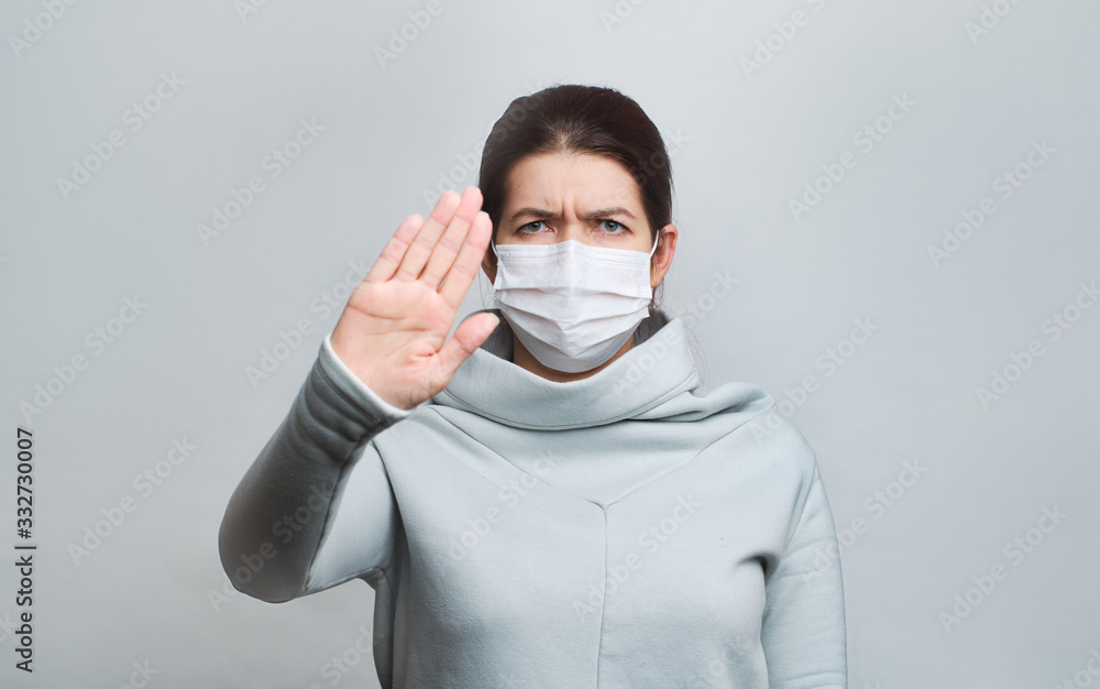 Woman in medical mask with outstretched arm isolated in studio Woman in medical mask with outstretched arm isolated in studio