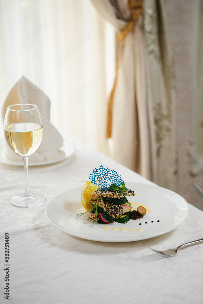 Veal is decorated with sesame seeds on the plate in a restaurant. Creative dish. Veal is decorated with sesame seeds on the plate in a restaurant. Creative dish.