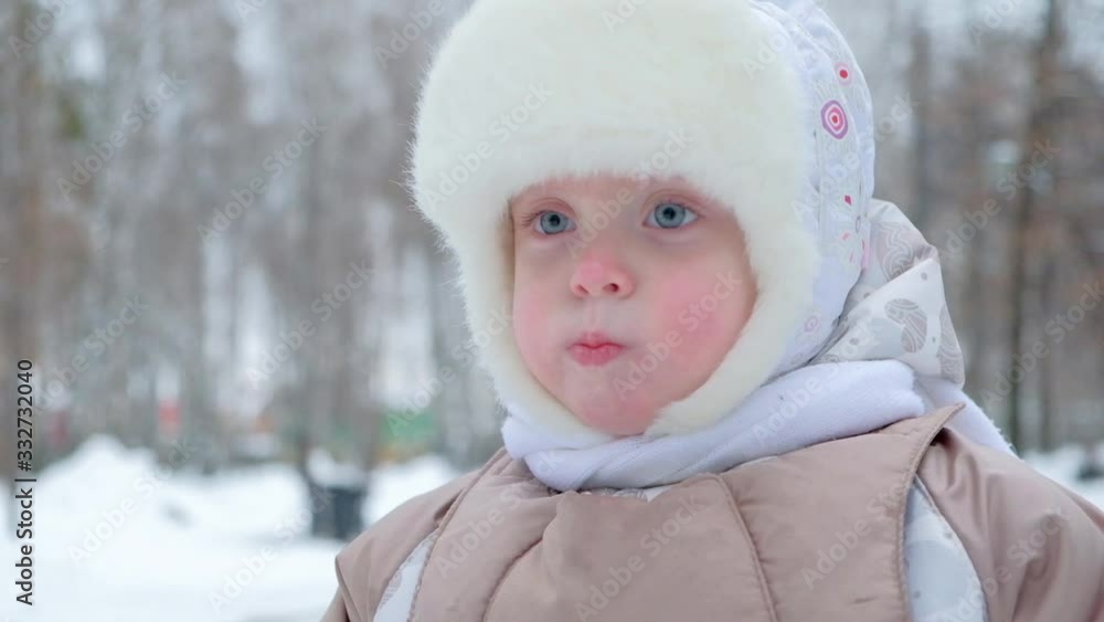 Adorable Girl in Winter Clothes Walk in City Park Adorable Girl in Winter Clothes Walk in City Park