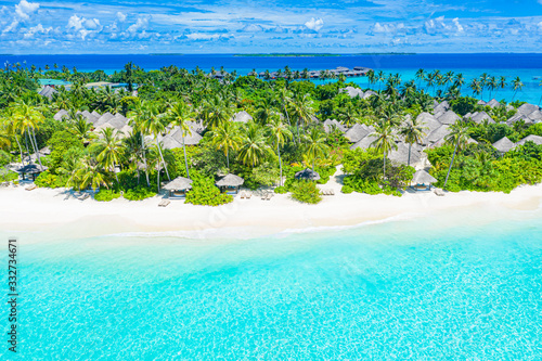 Fototapeta Naklejka Na Ścianę i Meble -  Perfect aerial landscape, luxury tropical resort or hotel with water bungalows villas and beautiful beach scenery. Amazing bird eyes view in Maldives, landscape seascape aerial view over a Maldives