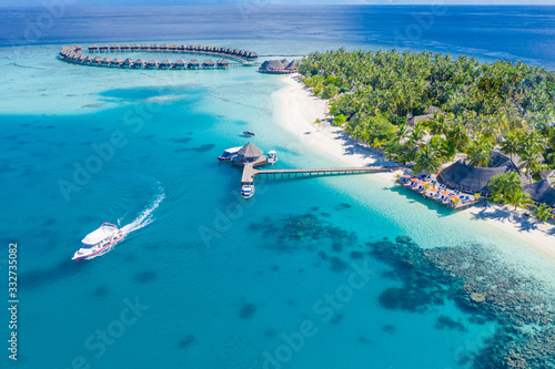 Canvas Print The drone photo with a wooden water villas seen from above and an amazing blue lagoon crystal clear water close to tropical lagoon