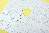 White puzzle on a colored background top view.