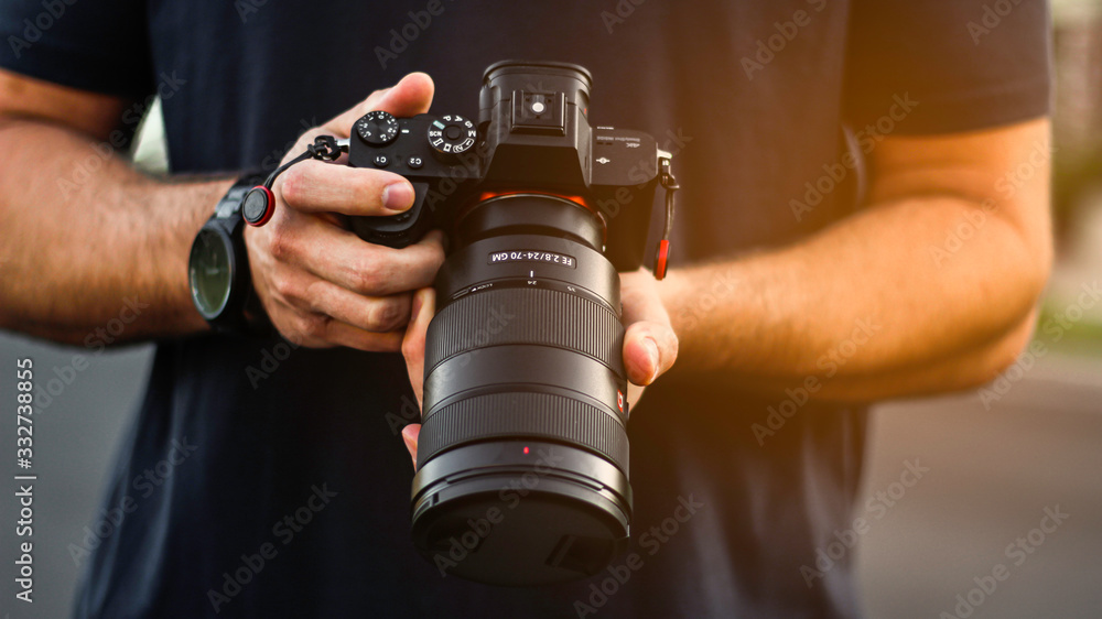 Photographer Holding DSLR Camera Photographer Holding DSLR Camera