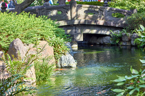 Stone bridge in Japanese garden on a sunny day