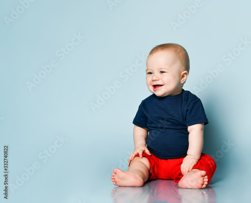 kid boy laughing on blue background