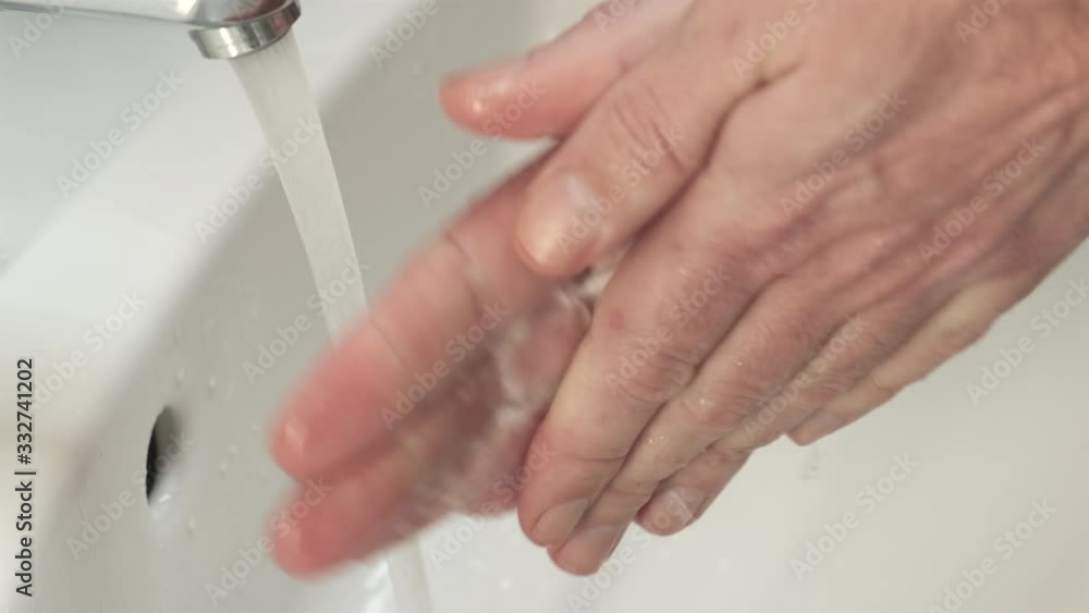 Washing hands in the bathroom sink to prevent spreading the coronovirus covid-19. Hygiene is an important prevention method to stop the virus from spreading. Washing hands in the bathroom sink to prevent spreading the coronovirus covid-19. Hygiene is an important prevention method to stop the virus from spreading.