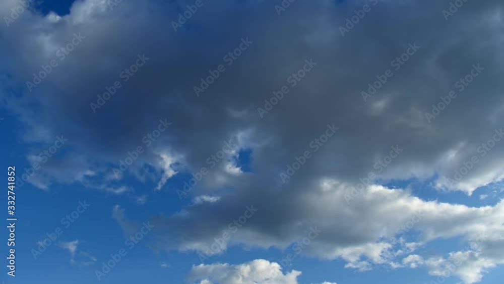 Cirrus clouds in a clear blue sky. White clouds move across the sky in spring. Cirrus clouds in a clear blue sky. White clouds move across the sky in spring.