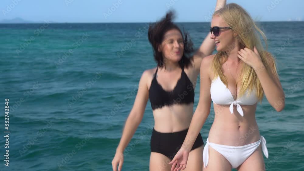 Happy beautiful two young woman in sexy bikini dancing and enjoy together in summer holiday on yacht cruise in the sea, girls with friend fun on boat in travel trip for relax, tropical holiday. Happy beautiful two young woman in sexy bikini dancing and enjoy together in summer holiday on yacht cruise in the sea, girls with friend fun on boat in travel trip for relax, tropical holiday.