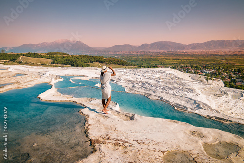 Turkey, Natural travertine pools and terraces in Pamukkale. Cotton castle in southwestern Turkey, girl in white dress with hat natural pool Pamukkale photo