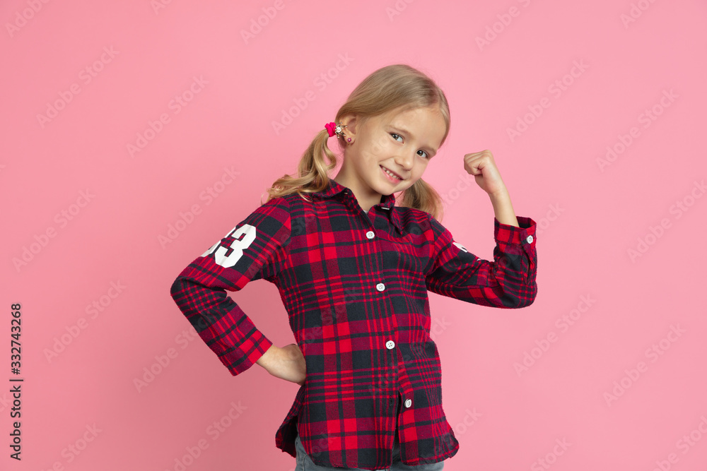Strong, successful. Caucasian little girl's portrait on pink studio background. Beautiful female model with blonde hair. Concept of human emotions, facial expression, sales, ad, youth, childhood. Strong, successful. Caucasian little girl's portrait on pink studio background. Beautiful female model with blonde hair. Concept of human emotions, facial expression, sales, ad, youth, childhood.