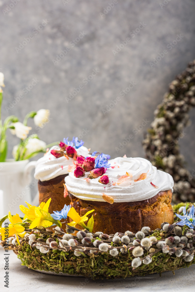 Easter Cake - Russian and Ukrainian Traditional Kulich or Brioche on a light stone background. Paska or Panettone Bread and spring flowers Easter Cake - Russian and Ukrainian Traditional Kulich or Brioche on a light stone background. Paska or Panettone Bread and spring flowers