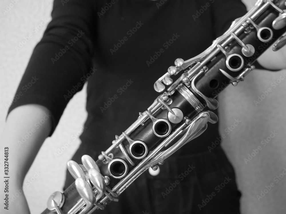 Obraz premium Clarinet player holding a clarinet in her hands.