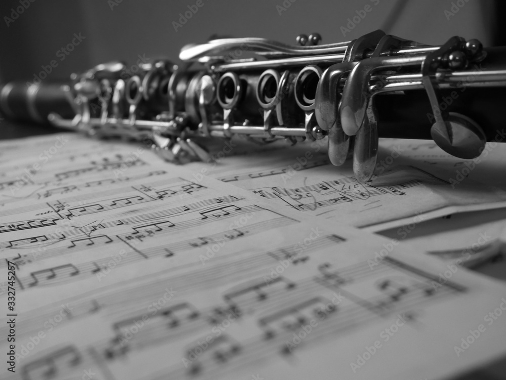 Obraz premium Close up of a clarinet music instrument and music notes . Black and white photo .