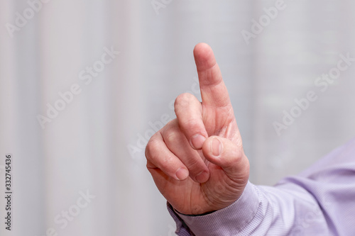 A man with his index finger raised up. Businessman pushes a button_
