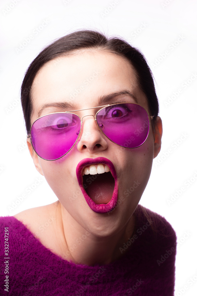 girl in a purple sweater, purple glasses with purple lipstick on her lips