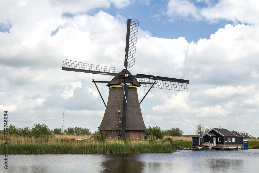 Netherlands rural lanscape with windmills at famous tourist site Kinderdijk, Rotterdam, in Holland. Old Dutch village Kinderdijk, UNESCO world heritage site.	