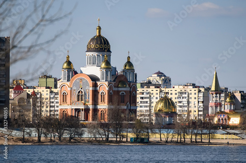 View to St. Pokrovskiy Cathedral Intercession and apartment buildings on Obolon embankment in Kyiv, Ukraine. March 2020 photo