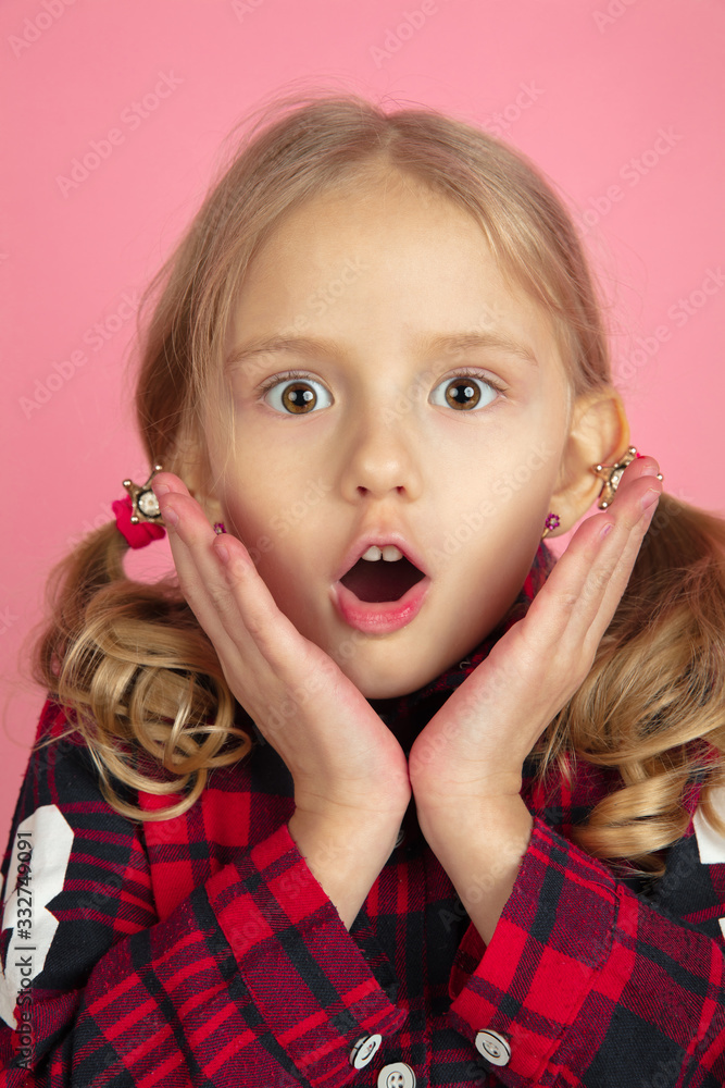 Shocked. Caucasian little girl's close up portrait on pink studio background. Beautiful female model with blonde hair. Concept of human emotions, facial expression, sales, ad, youth, childhood. Shocked. Caucasian little girl's close up portrait on pink studio background. Beautiful female model with blonde hair. Concept of human emotions, facial expression, sales, ad, youth, childhood.