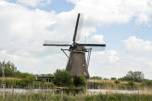 Netherlands rural lanscape with windmills at famous tourist site Kinderdijk, Rotterdam, in Holland. Old Dutch village Kinderdijk, UNESCO world heritage site. 