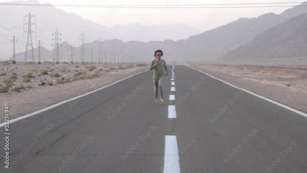 The guy runs on the highway in the desert The guy runs on the highway in the desert