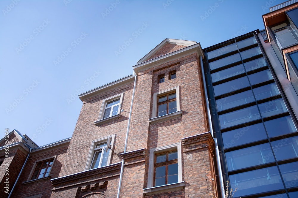 Exterior of new apartment buildings on a blue cloudy sky background. No people. Real estate business concept. Exterior of new apartment buildings on a blue cloudy sky background. No people. Real estate business concept.