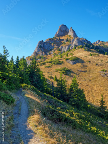 Fototapeta Naklejka Na Ścianę i Meble -  Beautiful morning landscape with a trail to the mountain peak